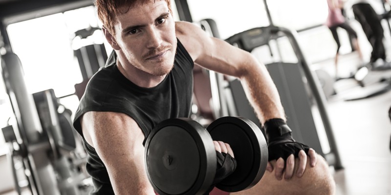 man with weight training equipment on sport gym club