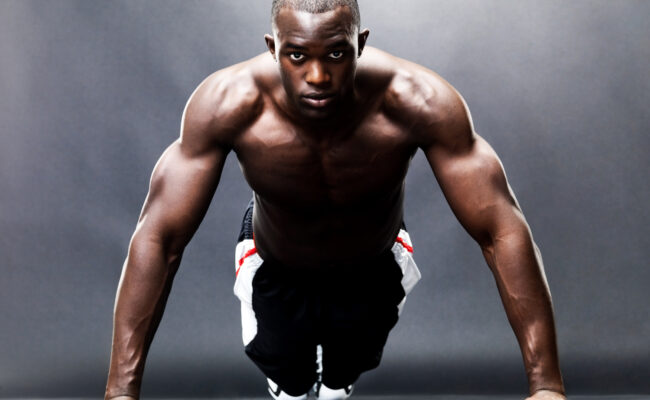 Bodybuilding – Healthy young guy doing push up exercise